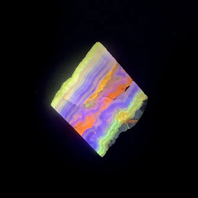 Hokkaidoite slice 1A01 under UV light (3/12) — 6.3 × 6 × 0.8 cm, Hokkaido, Japan · Kitsune Mineral