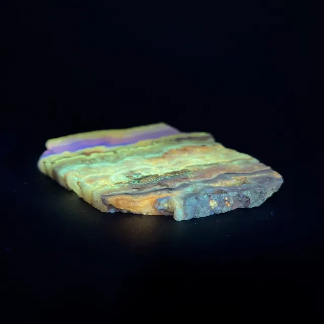 Hokkaidoite slice 1A02 under UV light (3/10) — 10 × 8.5 × 0.7 cm, Hokkaido, Japan · Kitsune Mineral