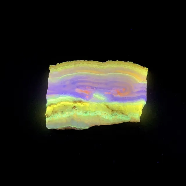 Hokkaidoite slice 1A03 under UV light (3/9) — 6.8 × 5 × 0.7 cm, Hokkaido, Japan · Kitsune Mineral