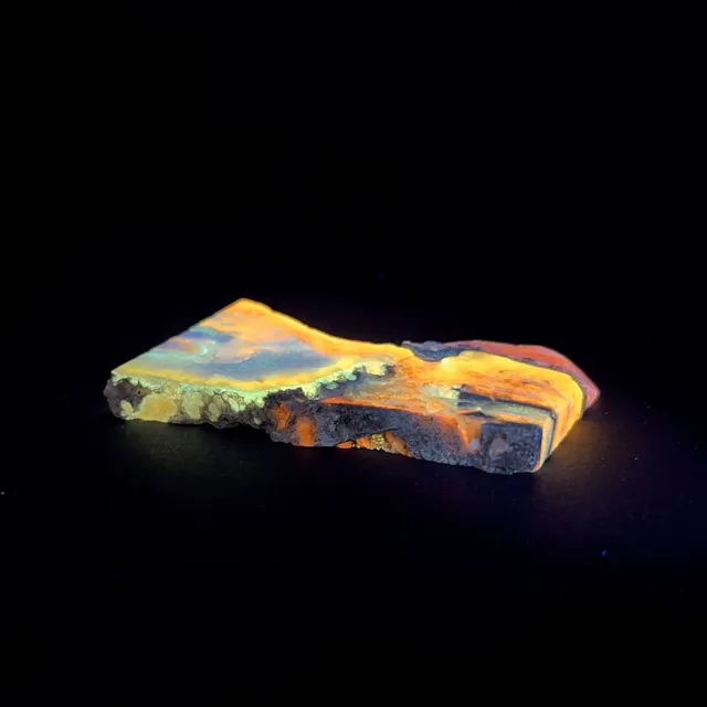 Hokkaidoite slice 1B01 under UV light (3/12) — 6.1 × 3.4 × 0.6 cm, Hokkaido, Japan · Kitsune Mineral