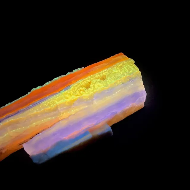 Hokkaidoite slice 1B02 under UV light (3/11) — 8.5 × 3.3 × 0.6 cm, Hokkaido, Japan · Kitsune Mineral