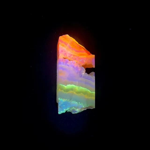 Hokkaidoite slice 1B04 under UV light (3/11) — 6 × 3 × 0.8 cm, Hokkaido, Japan · Kitsune Mineral