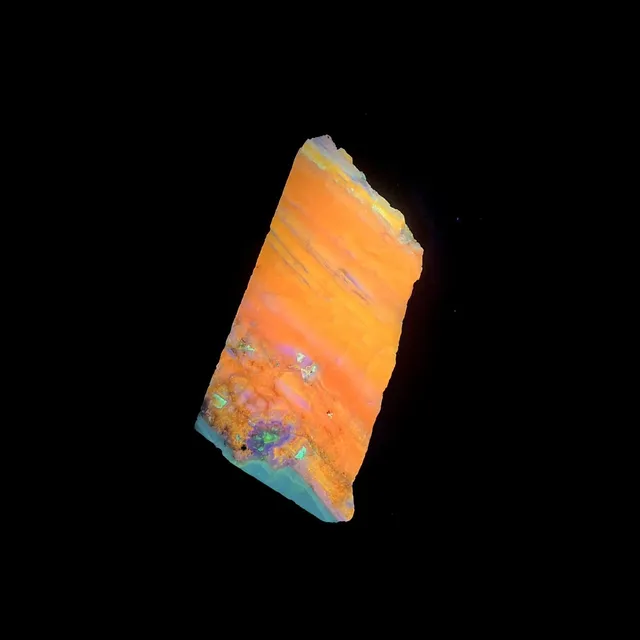 Hokkaidoite slice 1B06 under UV light (3/10) — 9 × 4.3 × 1.2 cm, Hokkaido, Japan · Kitsune Mineral