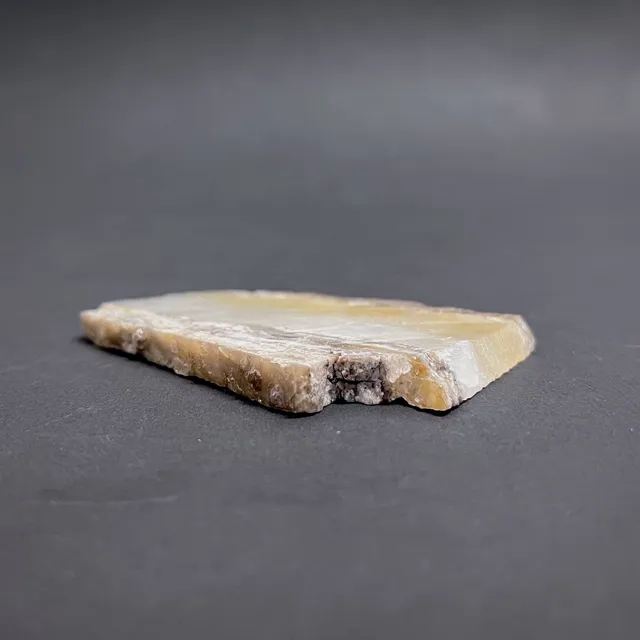 Hokkaidoite slice 1B07 in daylight (8/9) — 7.1 × 4.5 × 0.6 cm, Hokkaido, Japan · Kitsune Mineral