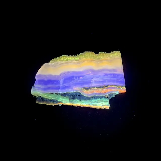 Hokkaidoite slice 1B07 under UV light (3/9) — 7.1 × 4.5 × 0.6 cm, Hokkaido, Japan · Kitsune Mineral