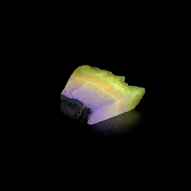 Hokkaidoite slice 1C02 under UV light (3/10) — 4.4 × 3.4 × 0.7 cm, Hokkaido, Japan · Kitsune Mineral