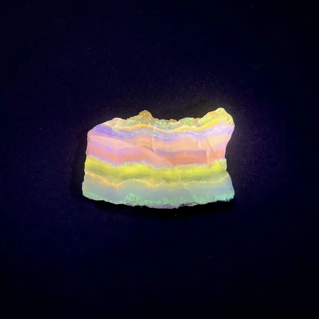 Hokkaidoite slice 1C04 under UV light (3/10) — 4.7 × 2.7 × 0.8 cm, Hokkaido, Japan · Kitsune Mineral