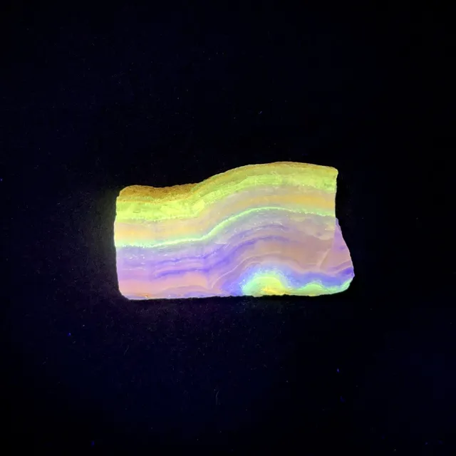 Hokkaidoite slice 1C05 under UV light (3/9) — 4.8 × 2.7 × 0.5 cm, Hokkaido, Japan · Kitsune Mineral