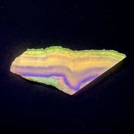 Hokkaidoite slice 1C07 under UV light (3/9) — 7.2 × 3 × 0.6 cm, Hokkaido, Japan · Kitsune Mineral
