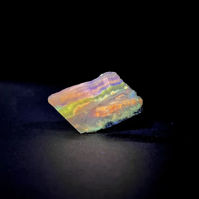Hokkaidoite slice 1C08 under UV light (3/15) — 5.1 × 2.8 × 0.7 cm, Hokkaido, Japan · Kitsune Mineral