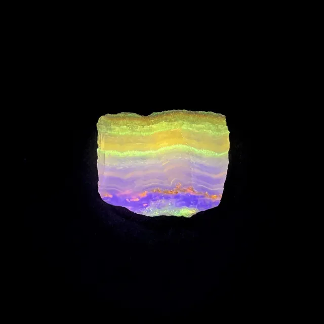 Hokkaidoite slice 1C09 under UV light (3/10) — 3.6 × 2.9 × 0.6 cm, Hokkaido, Japan · Kitsune Mineral
