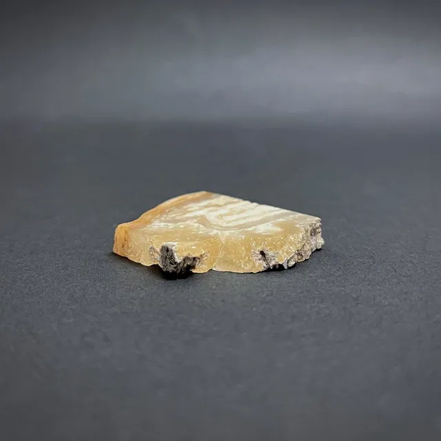 Hokkaidoite slice 1C10 in daylight (8/10) — 3.3 × 3.9 × 0.6 cm, Hokkaido, Japan · Kitsune Mineral