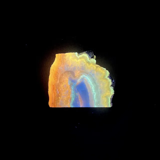 Hokkaidoite slice 1C10 under UV light (3/10) — 3.3 × 3.9 × 0.6 cm, Hokkaido, Japan · Kitsune Mineral
