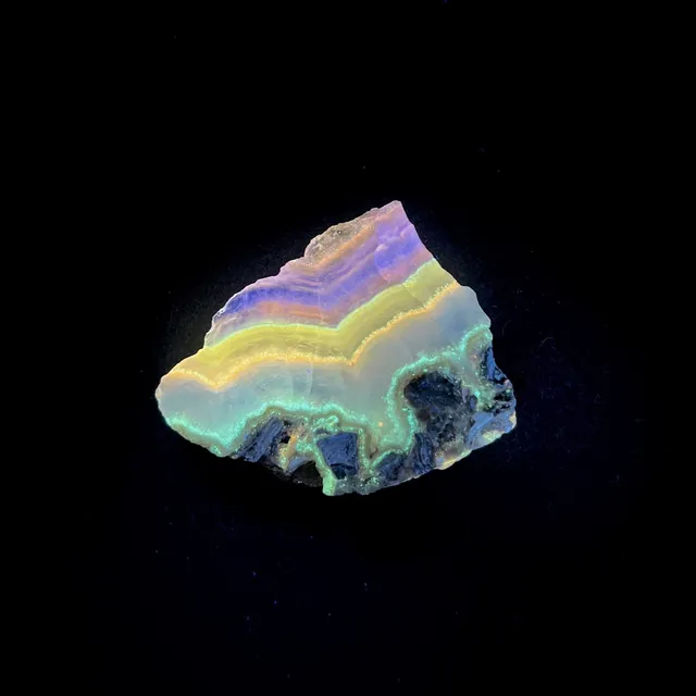 Hokkaidoite slice 1C12 under UV light (3/11) — 5.1 × 4 × 1 cm, Hokkaido, Japan · Kitsune Mineral
