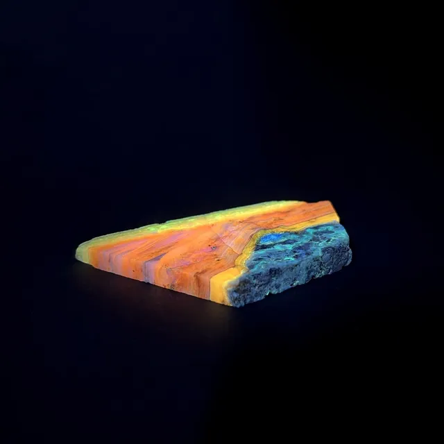 Hokkaidoite slice 2A01 under UV light (3/10) — 8.5 × 4.4 × 0.7 cm, Hokkaido, Japan · Kitsune Mineral
