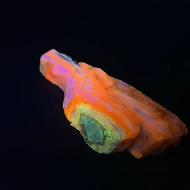 Hokkaidoite slice 2A02 under UV light (3/10) — 9.2 × 3.6 × 1.1 cm, Hokkaido, Japan · Kitsune Mineral