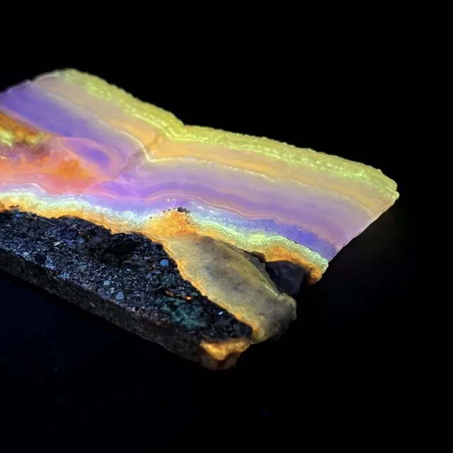 Hokkaidoite slice 2A04 under UV light (3/10) — 7.9 × 5.0 × 0.6 cm, Hokkaido, Japan · Kitsune Mineral
