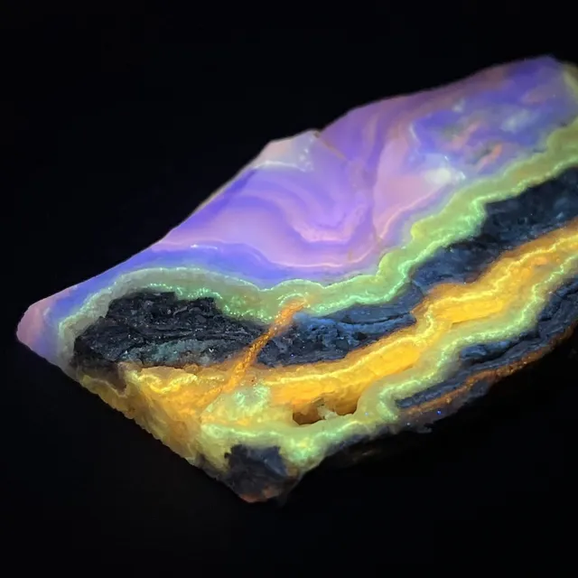 Hokkaidoite slice 2A05 under UV light (3/10) — 8.4 × 5.2 × 0.9 cm, Hokkaido, Japan · Kitsune Mineral