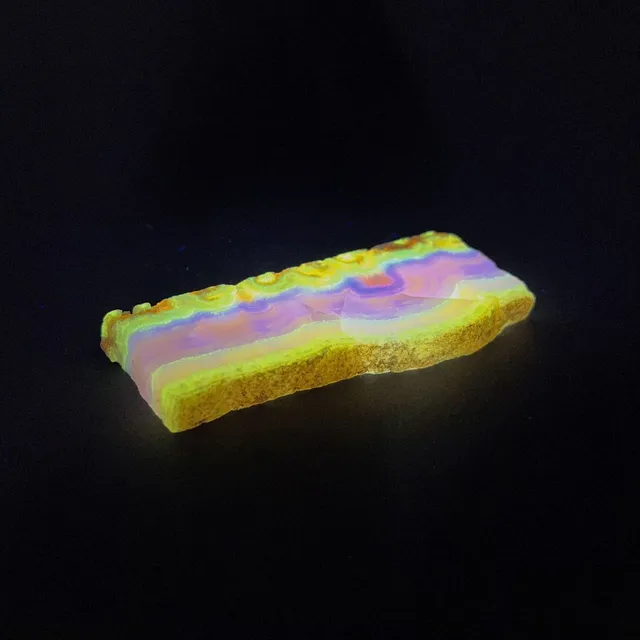 Hokkaidoite slice 2A07 under UV light (3/9) — 9.2 × 4.2 × 1 cm, Hokkaido, Japan · Kitsune Mineral
