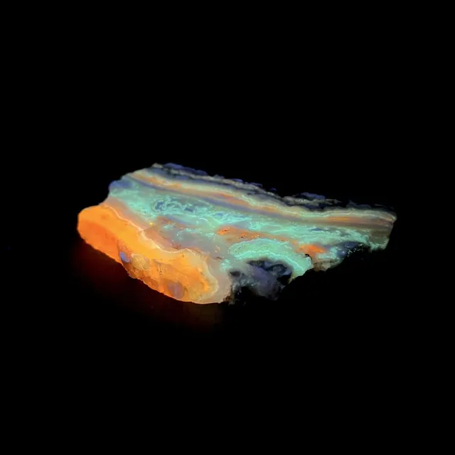 Hokkaidoite slice 2B06 under UV light (3/9) — 7.7 × 4.6 × 0.7 cm, Hokkaido, Japan · Kitsune Mineral