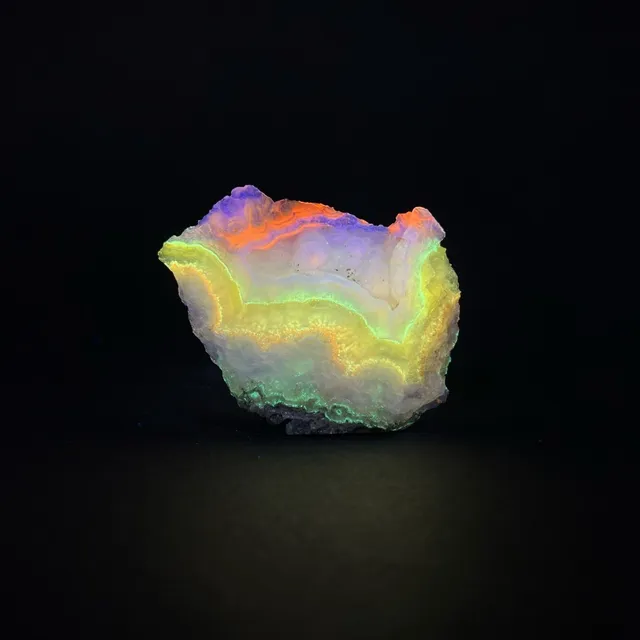 Hokkaidoite slice 2B07 under UV light (3/10) — 6.6 × 4.9 × 0.7 cm, Hokkaido, Japan · Kitsune Mineral
