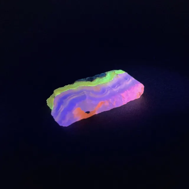 Hokkaidoite slice 2B08 under UV light (3/9) — 5.5 × 2.8 × 0.7 cm, Hokkaido, Japan · Kitsune Mineral