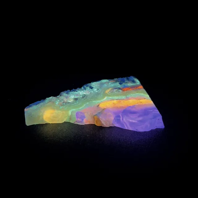 Hokkaidoite slice 2B10 under UV light (3/9) — 6.6 × 3.8 × 0.7 cm, Hokkaido, Japan · Kitsune Mineral