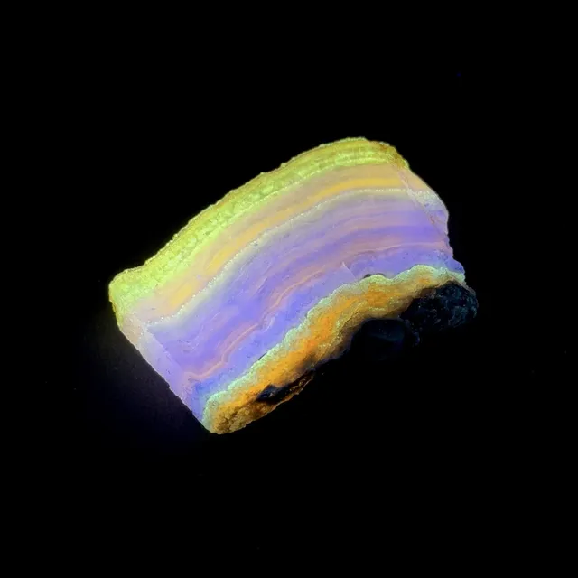 Hokkaidoite slice 2C03 under UV light (3/9) — 5.2 × 3.6 × 0.6 cm, Hokkaido, Japan · Kitsune Mineral