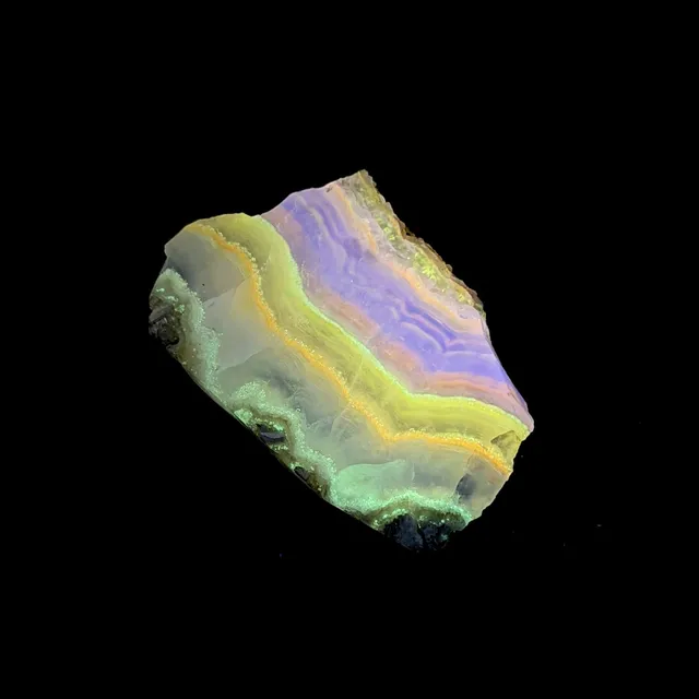 Hokkaidoite slice 2C04 under UV light (3/9) — 4.6 × 3.0 × 0.6 cm, Hokkaido, Japan · Kitsune Mineral