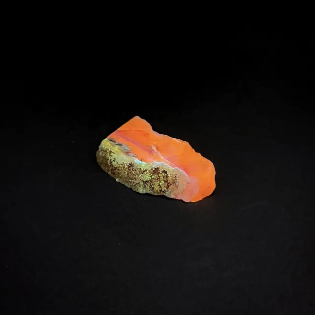 Hokkaidoite slice 2C05 under UV light (3/10) — 4.5 × 2.6 × 0.7 cm, Hokkaido, Japan · Kitsune Mineral