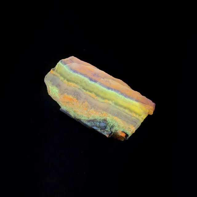 Hokkaidoite slice 2C06 under UV light (3/9) — 5.4 × 2.9 × 0.5 cm, Hokkaido, Japan · Kitsune Mineral