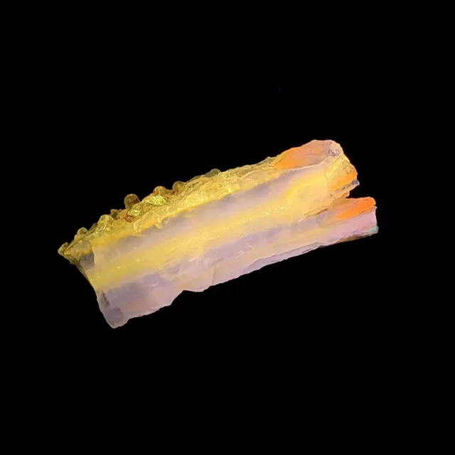 Hokkaidoite slice 2C12 under UV light (3/9) — 5.3 × 1.9 × 1.0 cm, Hokkaido, Japan · Kitsune Mineral