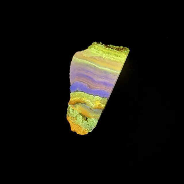 Hokkaidoite slice 2C13 under UV light (3/9) — 4.5 × 2.2 × 0.8 cm, Hokkaido, Japan · Kitsune Mineral