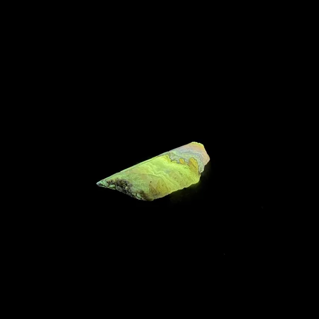 Hokkaidoite slice 2C15 under UV light (3/10) — 4.2 × 2.2 × 0.6 cm, Hokkaido, Japan · Kitsune Mineral