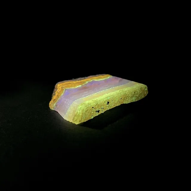Hokkaidoite slice AL01 under UV light (3/8) — 5.7 × 4.2 × 0.7 cm, Hokkaido, Japan · Kitsune Mineral