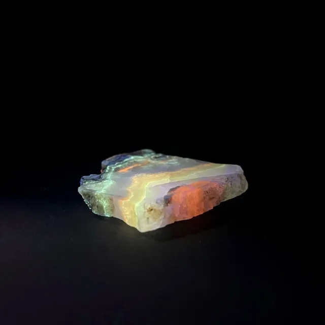 Hokkaidoite slice AL02 under UV light (3/7) — 5.2 × 5 × 0.7 cm, Hokkaido, Japan · Kitsune Mineral