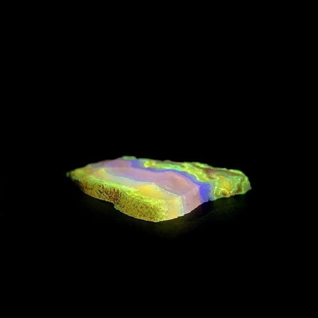 Hokkaidoite slice AL03 under UV light (3/9) — 6.7 × 5.2 × 0.7 cm, Hokkaido, Japan · Kitsune Mineral