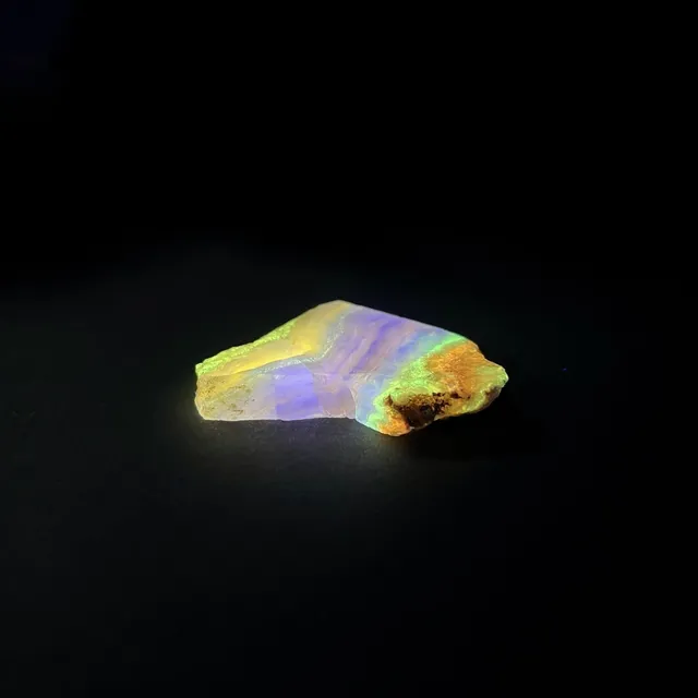 Hokkaidoite slice AM01 under UV light (3/9) — 5.0 × 4.1 × 0.7 cm, Hokkaido, Japan · Kitsune Mineral