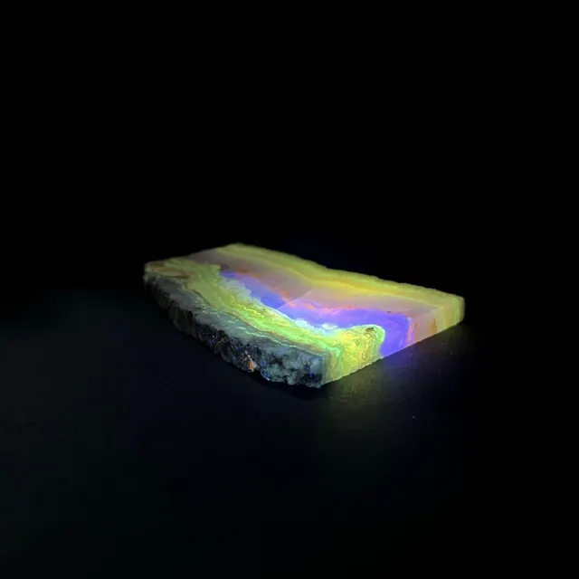 Hokkaidoite slice AXL01 under UV light (3/9) — 8.7 × 6.4 × 0.7 cm, Hokkaido, Japan · Kitsune Mineral