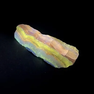Hokkaidoite slice BL01 under UV light (3/11) — 7.3 × 2.9 × 1.1 cm, Hokkaido, Japan · Kitsune Mineral