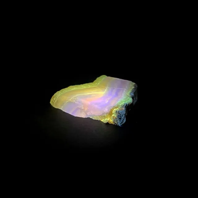 Hokkaidoite slice BM02 under UV light (3/8) — 3.8 × 4.4 × 0.7 cm, Hokkaido, Japan · Kitsune Mineral