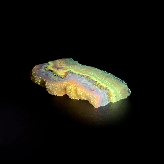 Hokkaidoite slice BXL01 under UV light (3/10) — 9.0 × 5.2 × 1.0 cm, Hokkaido, Japan · Kitsune Mineral