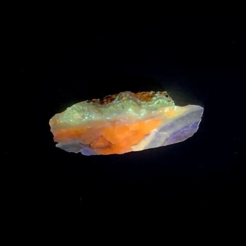 Hokkaidoite slice CS02 under UV light (3/8) — 4.6 × 2.0 × 0.7 cm, Hokkaido, Japan · Kitsune Mineral